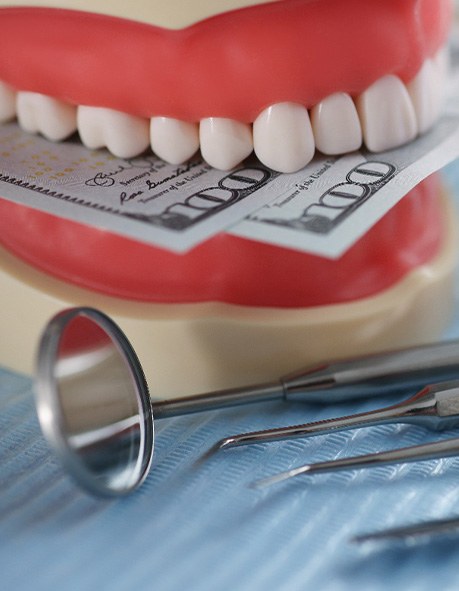 A mock jaw biting a few hundred-dollar bills