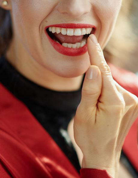 Woman pointing to her tooth