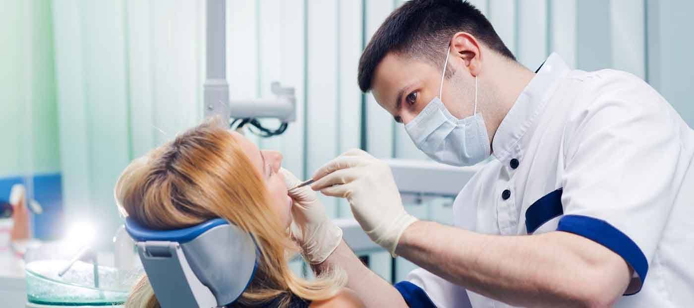 Dentist examining woman’s mouth