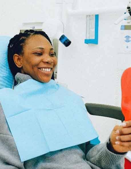 Smiling woman in dentist’s chair