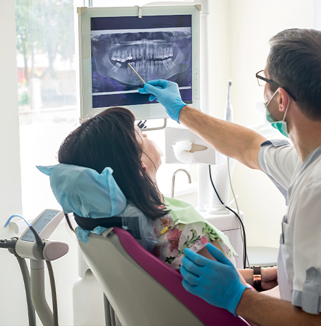 Dentist showing a patient an x ray of their teeth