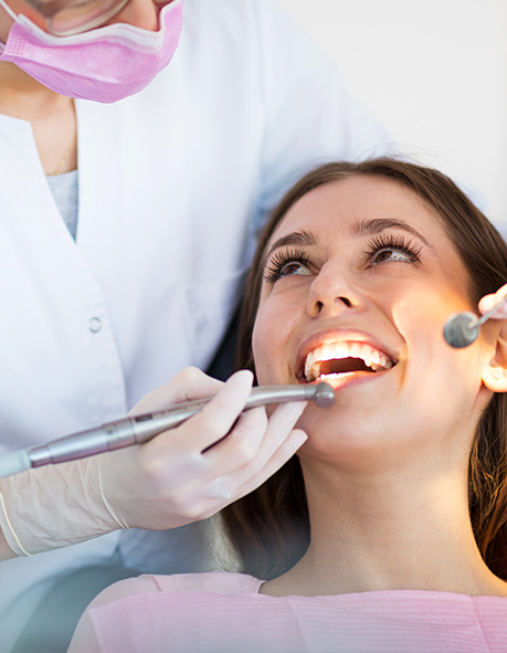 Woman in dental chair receiving a dental exam