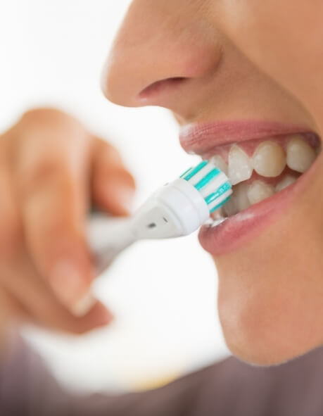 Close up of person brushing their teeth