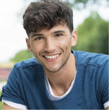 Smiling young man in blue tee shirt